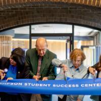 Bob Thompson, President Mantella, and 4 others cutting ribbon into new Success Center space